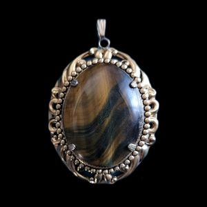 Large gold tone ornate tiger eye pendant